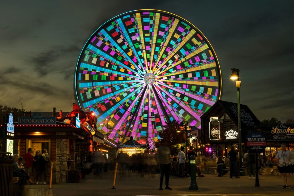 pexels-photo-14266267-14266267 A vibrant Ferris wheel illuminated at night in Pigeon Forge, Tennessee.