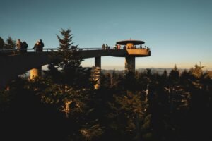 Visitors enjoy a scenic view at Clingmans Dome in the Great Smoky Mountains during twilight.